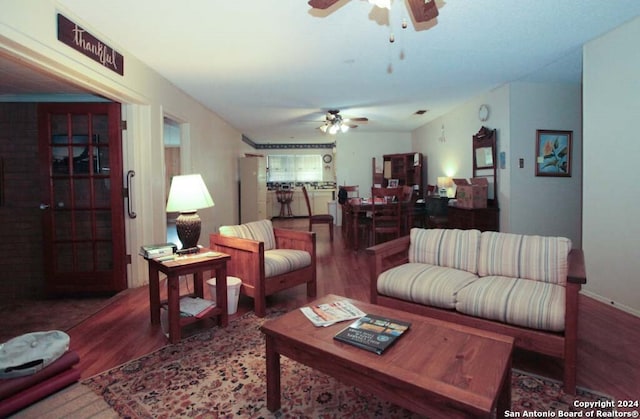 living room with ceiling fan and wood-type flooring