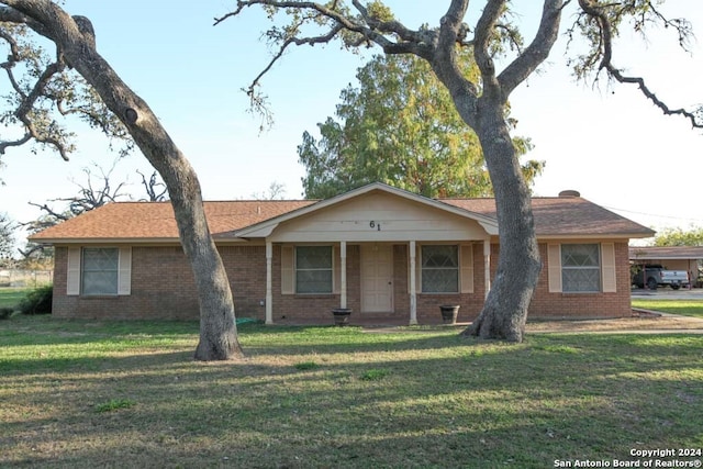 single story home with a front lawn and a porch