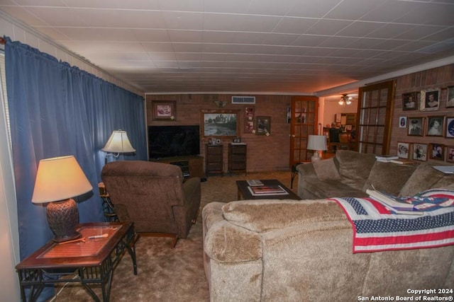 living room featuring carpet flooring and wooden walls