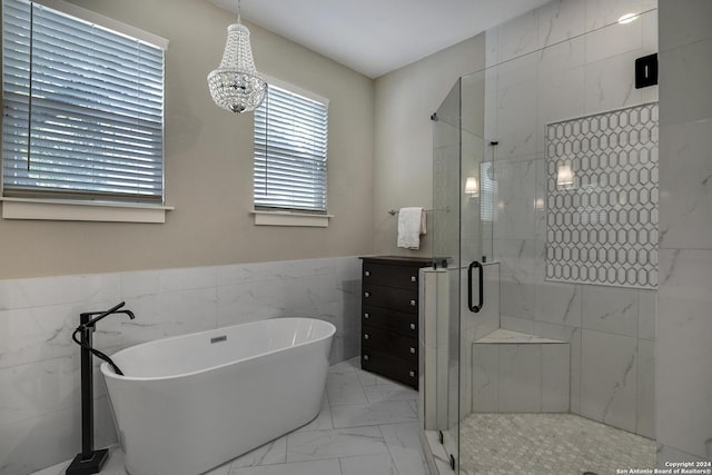 403 Queen Anne Ct, San Antonio, TX 78209 - full bathroom featuring marble finish floor, tile walls, a stall shower, wainscoting, and a freestanding tub