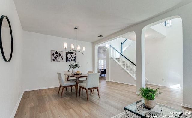 dining room featuring light hardwood / wood-style floors and an inviting chandelier