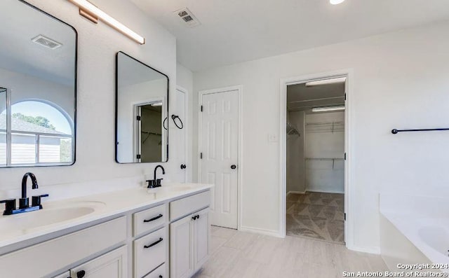 bathroom with vanity and a bathtub