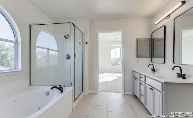 bathroom with tile patterned flooring, vanity, and shower with separate bathtub