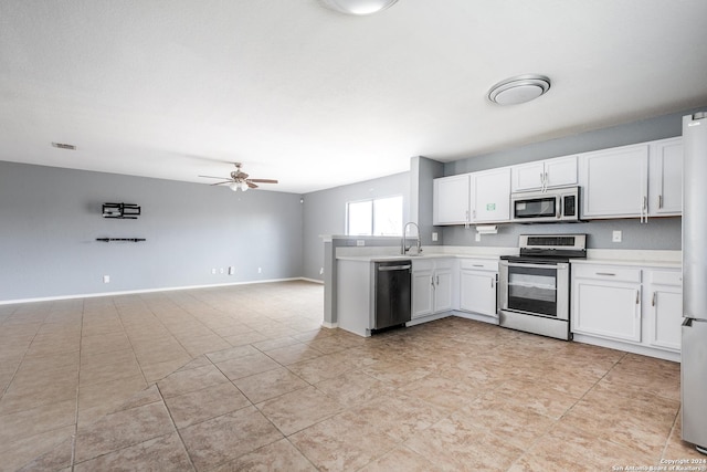 kitchen featuring white cabinets, sink, ceiling fan, appliances with stainless steel finishes, and light tile patterned flooring