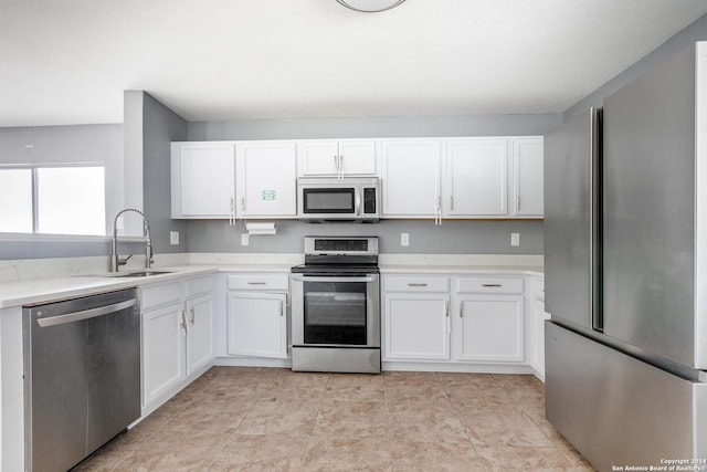 kitchen with white cabinets, stainless steel appliances, and sink