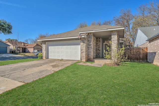 ranch-style house featuring a front yard and a garage