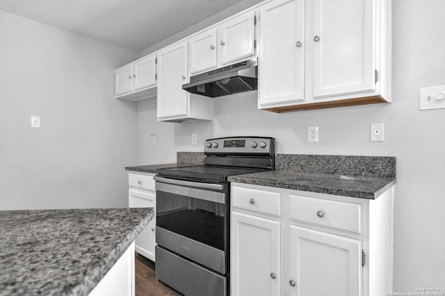 kitchen featuring white cabinets, stainless steel electric range oven, and dark wood-type flooring