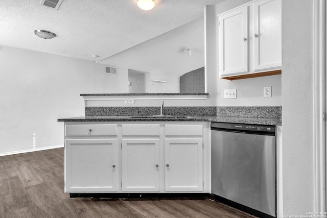 kitchen with dishwasher, dark stone countertops, white cabinetry, and sink