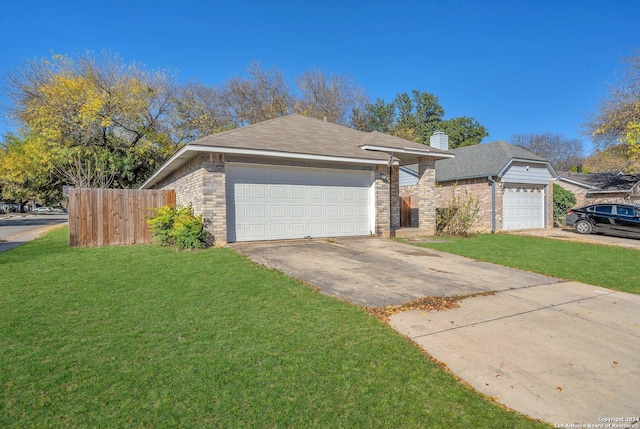 ranch-style home featuring a garage and a front lawn