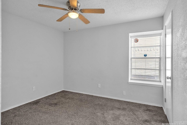 carpeted empty room with a textured ceiling and ceiling fan