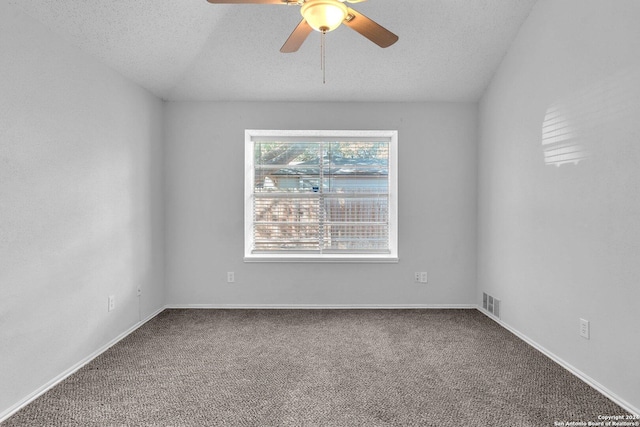 spare room with a textured ceiling, carpet floors, and ceiling fan