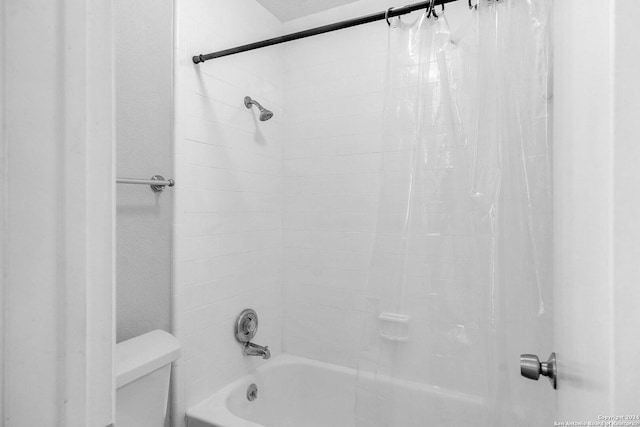 bathroom with shower / tub combo with curtain and toilet