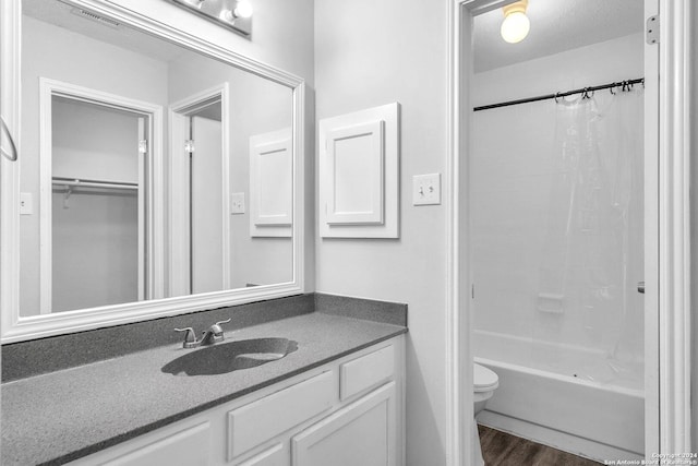 full bathroom featuring toilet, hardwood / wood-style floors, vanity, and shower / tub combo with curtain