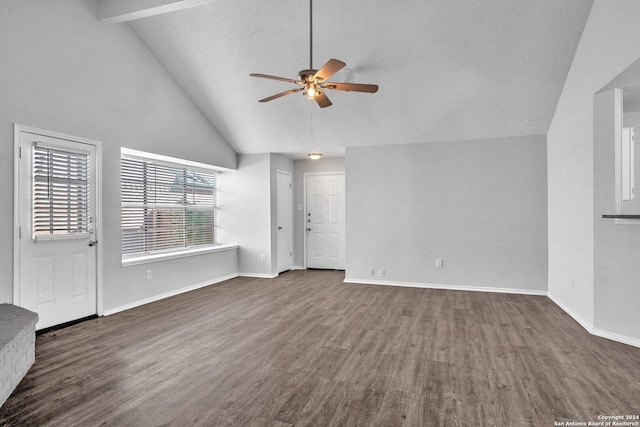 unfurnished living room featuring dark hardwood / wood-style flooring, vaulted ceiling with beams, a textured ceiling, and ceiling fan