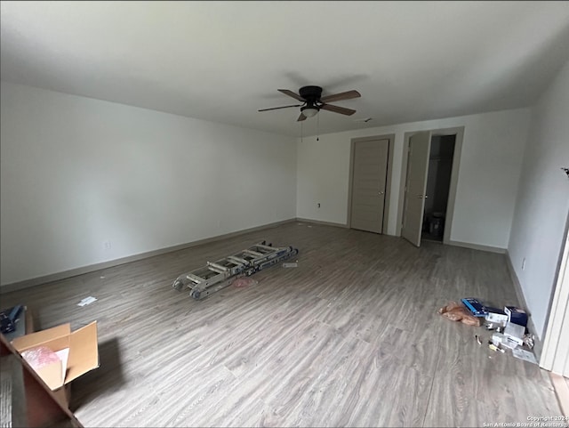 interior space with ceiling fan and light hardwood / wood-style flooring