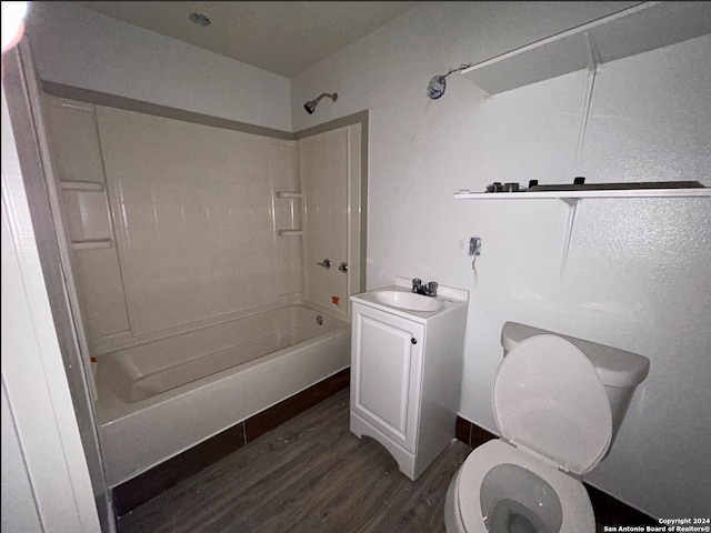 full bathroom featuring vanity, wood-type flooring, bathtub / shower combination, and toilet