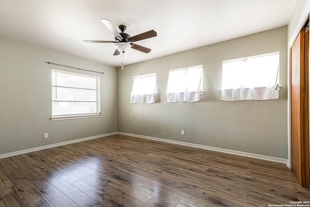 spare room featuring dark hardwood / wood-style floors and ceiling fan