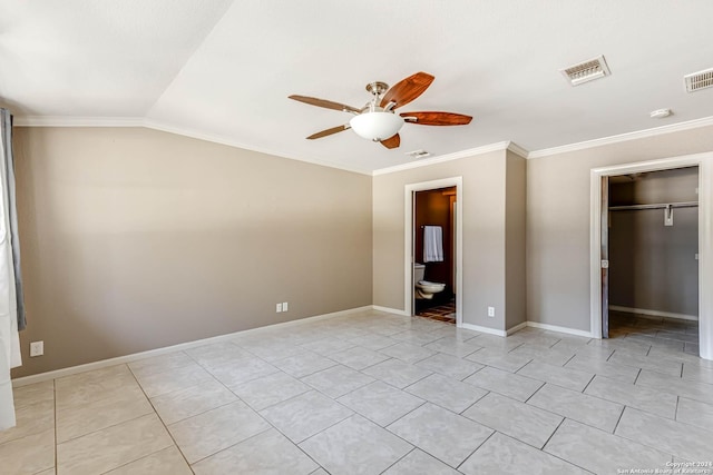 unfurnished bedroom with vaulted ceiling, ensuite bath, ceiling fan, ornamental molding, and a closet