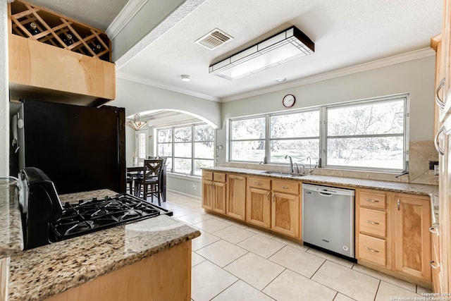 kitchen featuring black appliances, light stone counters, light tile patterned floors, and crown molding