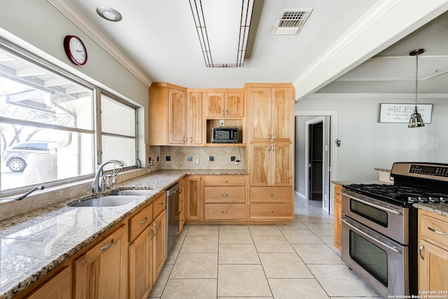 kitchen featuring hanging light fixtures, sink, light tile patterned floors, and stainless steel appliances