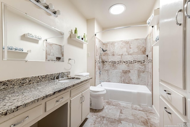 full bathroom featuring toilet, vanity, and tiled shower / bath