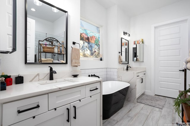 bathroom with a bathing tub and vanity