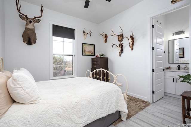 bedroom featuring ceiling fan, connected bathroom, and light hardwood / wood-style flooring