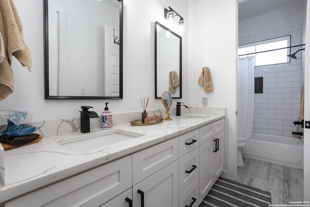 full bathroom with vanity, toilet, wood-type flooring, and shower / bath combo