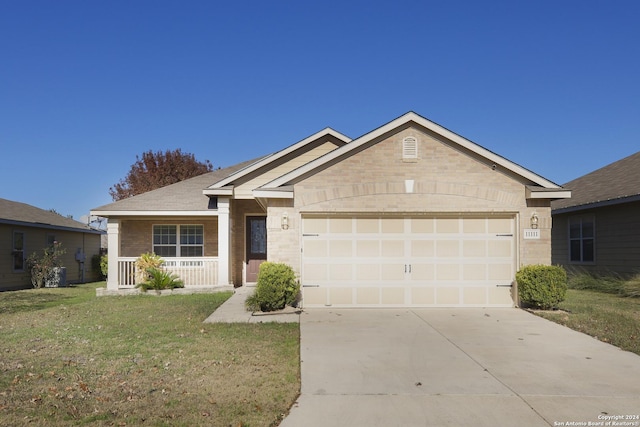 single story home featuring a porch, a garage, and a front lawn