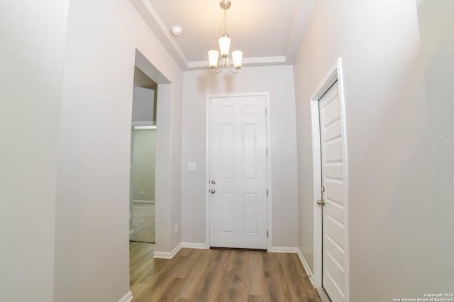 hallway featuring a notable chandelier and wood-type flooring