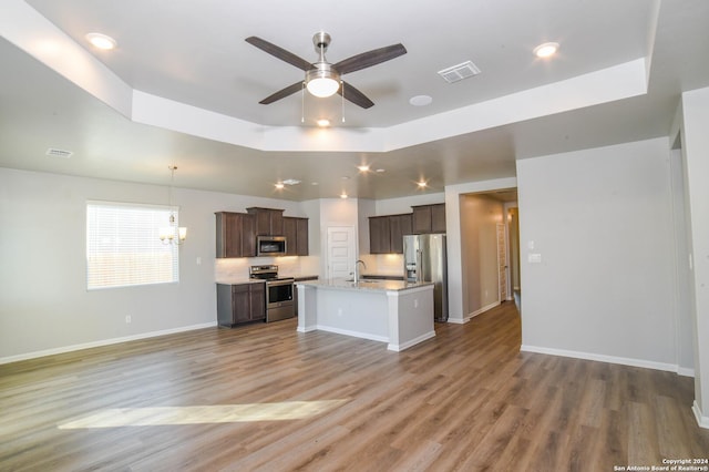 kitchen with a center island with sink, wood-type flooring, stainless steel appliances, and sink