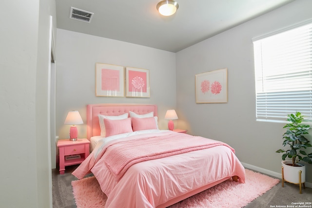 bedroom with dark colored carpet