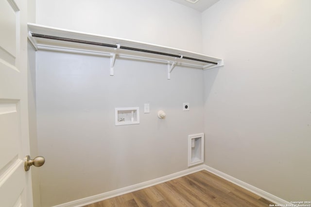 washroom with hardwood / wood-style floors, electric dryer hookup, hookup for a gas dryer, and washer hookup