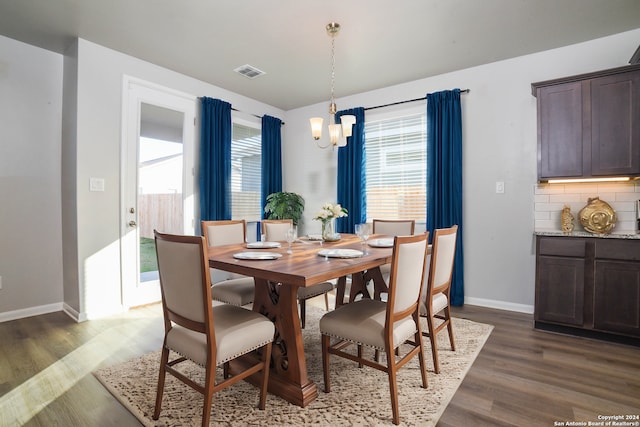 dining space with a chandelier and dark hardwood / wood-style floors