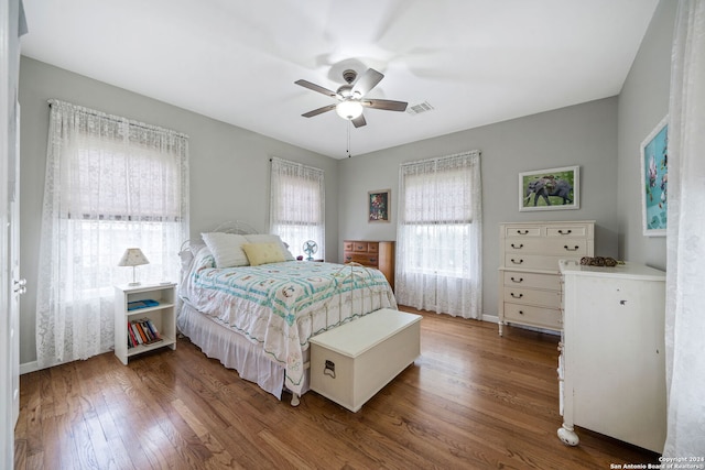 bedroom with ceiling fan and dark wood-type flooring