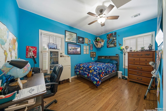 bedroom with ceiling fan and hardwood / wood-style floors