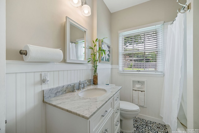 bathroom featuring toilet, vanity, and tile patterned floors