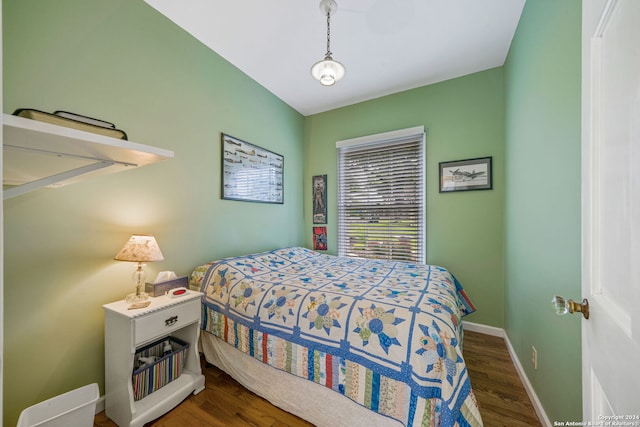 bedroom with dark hardwood / wood-style flooring