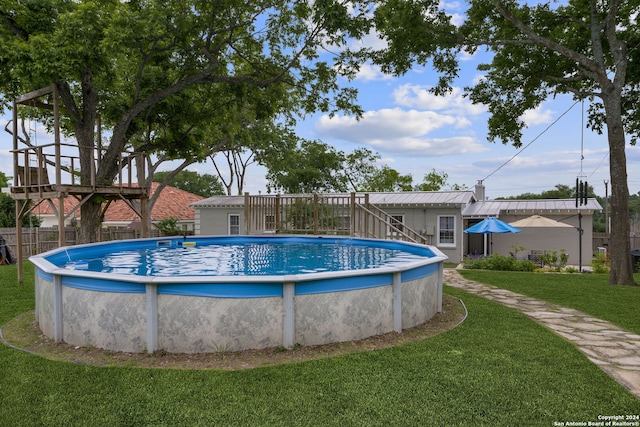 view of pool with a yard