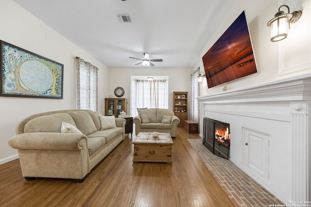 living room with hardwood / wood-style flooring and ceiling fan