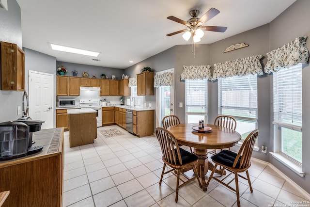 kitchen featuring tasteful backsplash, stainless steel appliances, ceiling fan, sink, and light tile patterned flooring