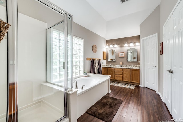 bathroom with hardwood / wood-style floors, vanity, and separate shower and tub