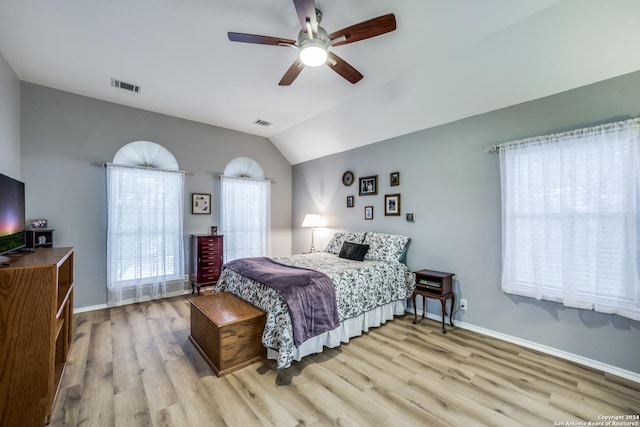 bedroom featuring light hardwood / wood-style floors, vaulted ceiling, and ceiling fan