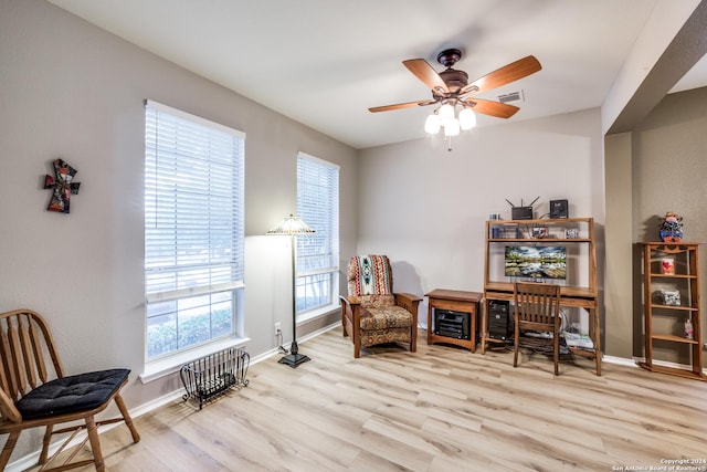 living area with ceiling fan and light wood-type flooring