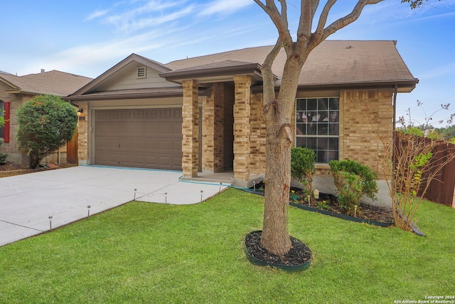 single story home featuring a front lawn and a garage