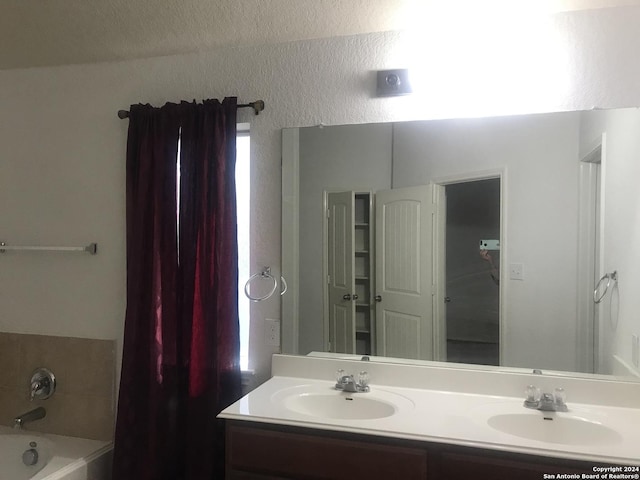 bathroom featuring vanity and a tub to relax in