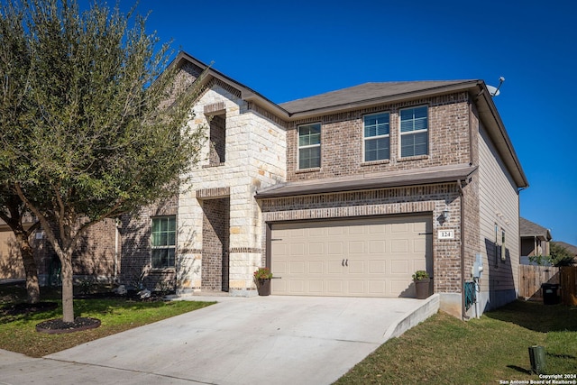 view of front facade with a garage and a front lawn