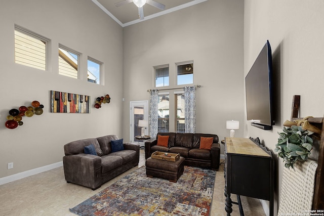 living room featuring crown molding, ceiling fan, light tile patterned flooring, and a high ceiling