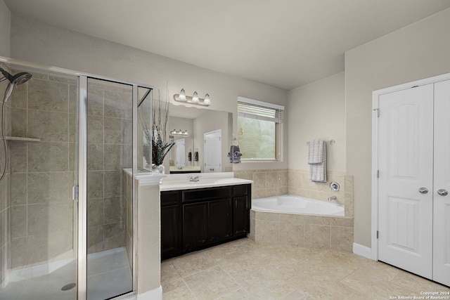 bathroom featuring vanity and separate shower and tub