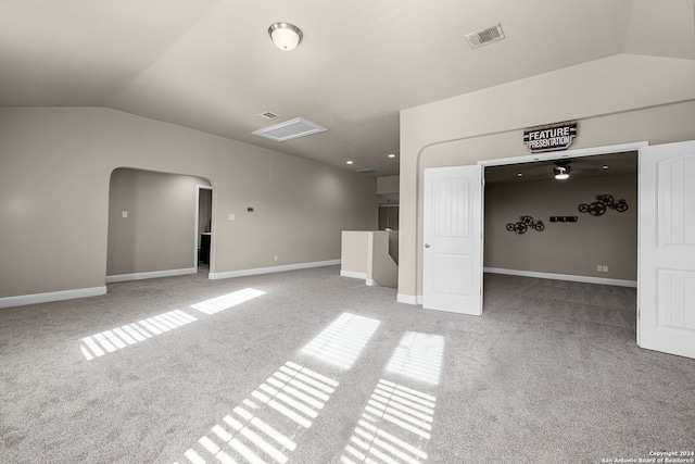 carpeted empty room featuring ceiling fan and lofted ceiling